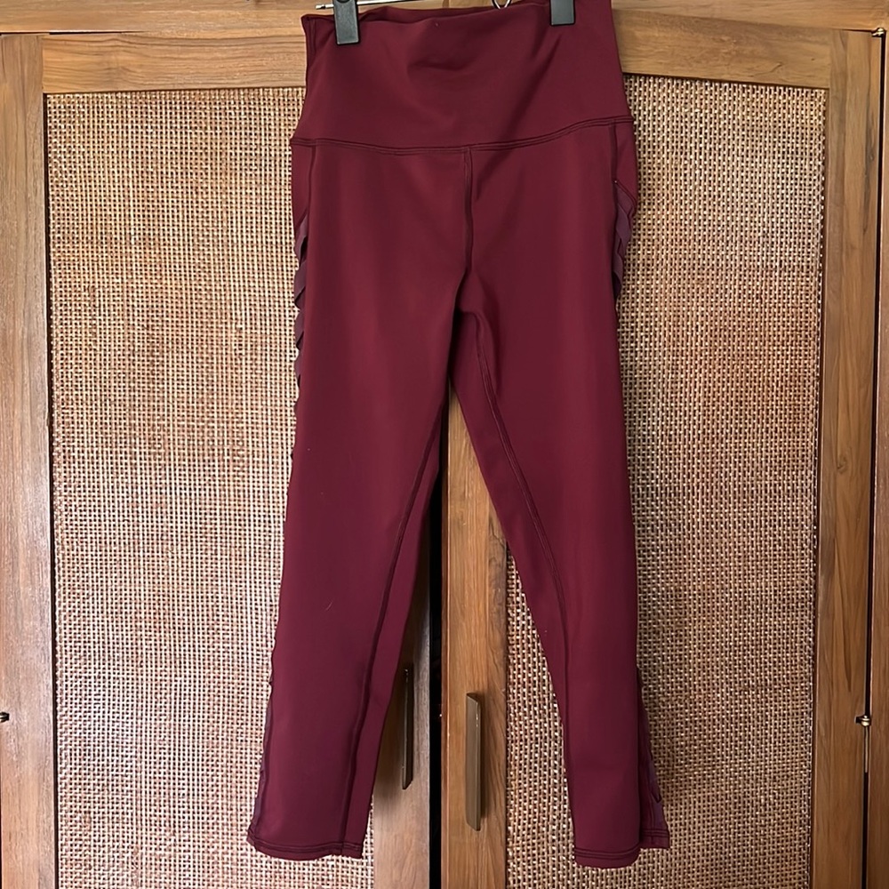 Maroon alo leggings with mesh and crisscross detail siding